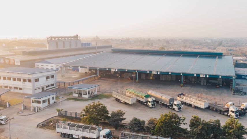 DHM Packers and Movers transport trucks near warehouse