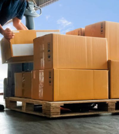 Workers Courier Lifting Packaging Boxes on Pallet. Cardboard Boxes. Shipping Supplies Warehouse. Shipment Boxes. Storehouse. Cargo Warehouse Logistics.